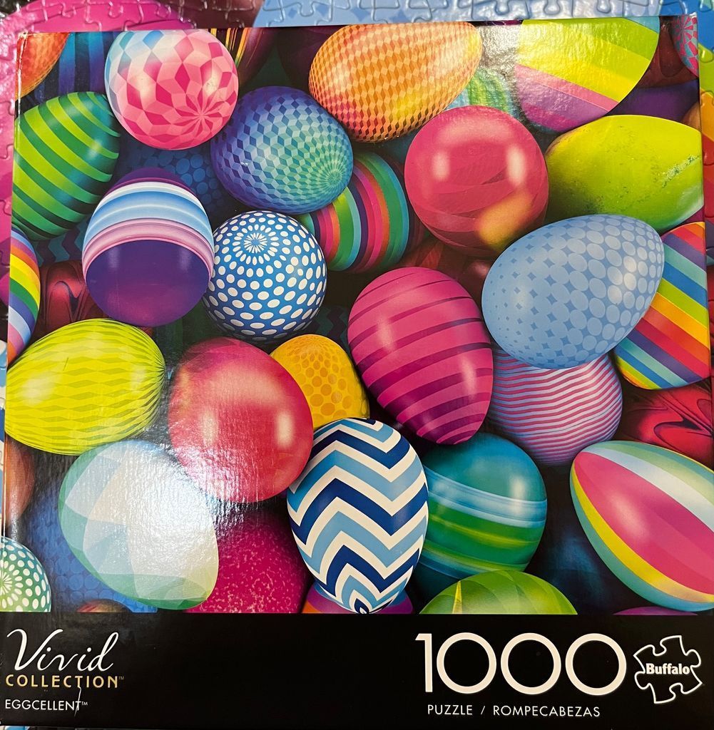 A dense, vibrant collection of colorful, patterned Easter eggs piled together.