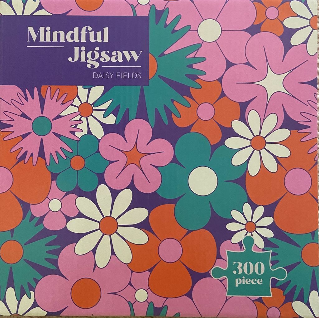 Pattern of stylized 1970s-inspired retro flowers in pink, orange, teal, and cream on a purple background.