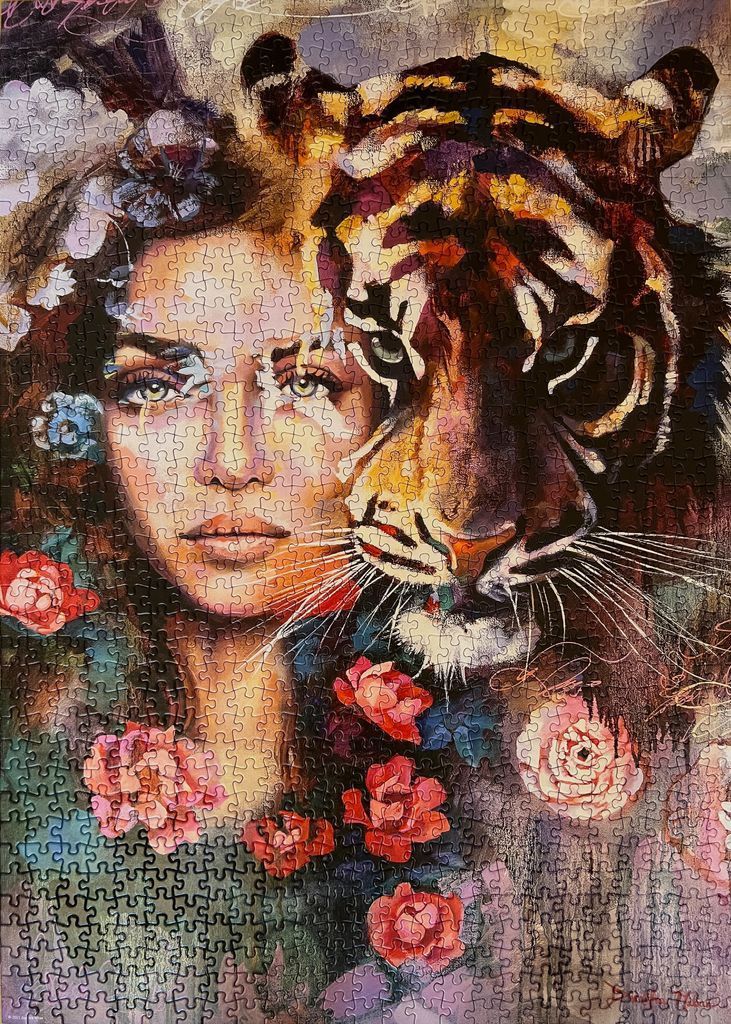 An artistic portrait blending the face of a woman and a tiger amidst floral accents.