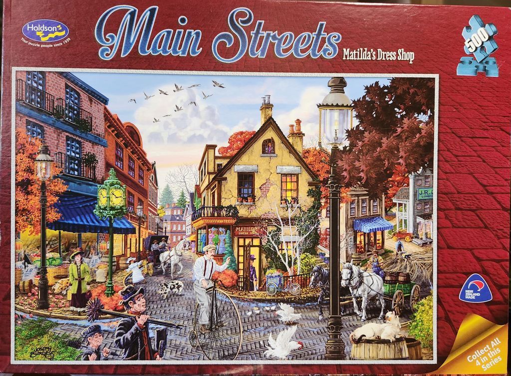 A nostalgic street scene featuring Matilda's Dress Shop with a man on a penny-farthing bicycle and horse-drawn carts.
