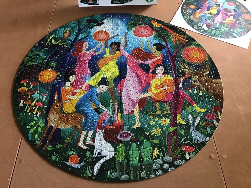 Circular illustration of diverse women dancing and performing rituals in a moonlit forest with woodland creatures.