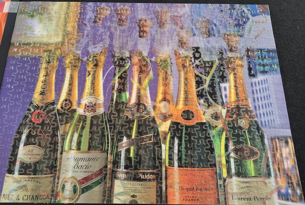 Seven vintage champagne bottles standing in a row with their corks popping in mid-air