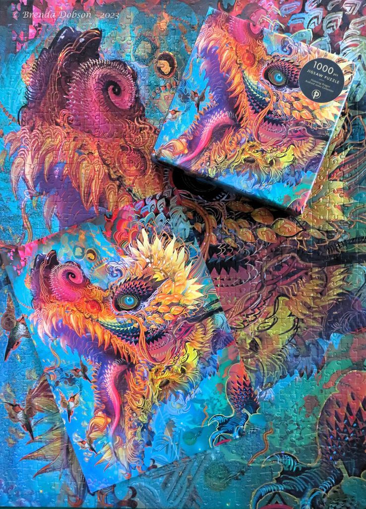 A vibrant digital artwork featuring a kaleidoscopic dragon head surrounded by hummingbirds and ornate patterns.