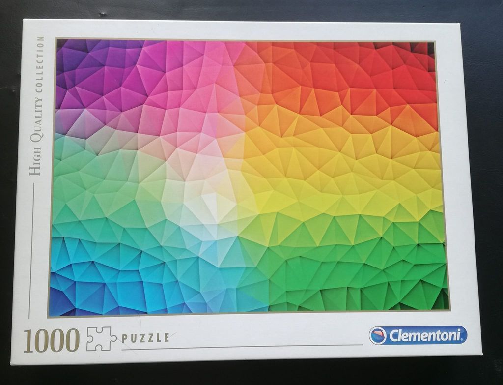 A geometric abstract design composed of many multicolored triangles in a spectrum gradient.