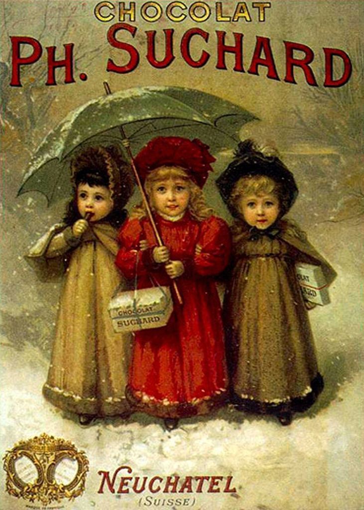 Three young girls in winter coats and hats standing together under a large umbrella in a snowy landscape.