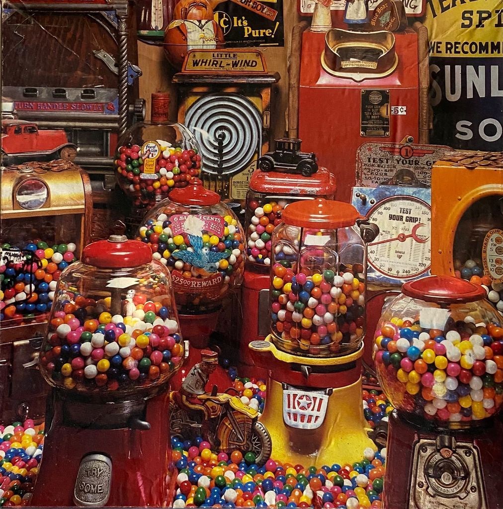 A dense collection of antique vending machines filled with colorful gumballs.
