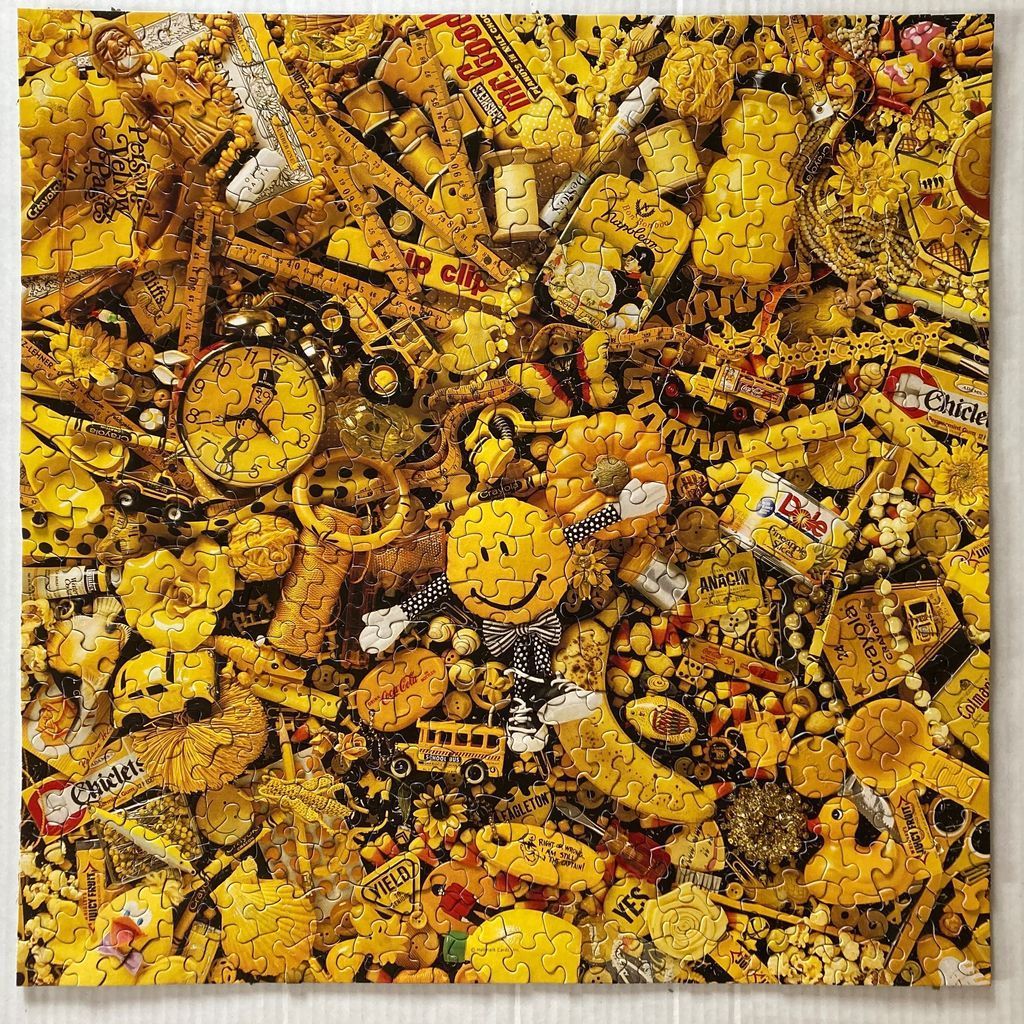 A cluttered collage of numerous yellow objects including toys, food, and household items.