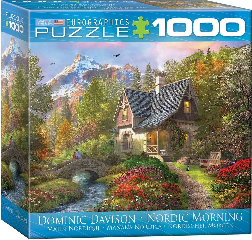 A cozy cottage by a stone bridge and stream with snow-capped mountains in the background.