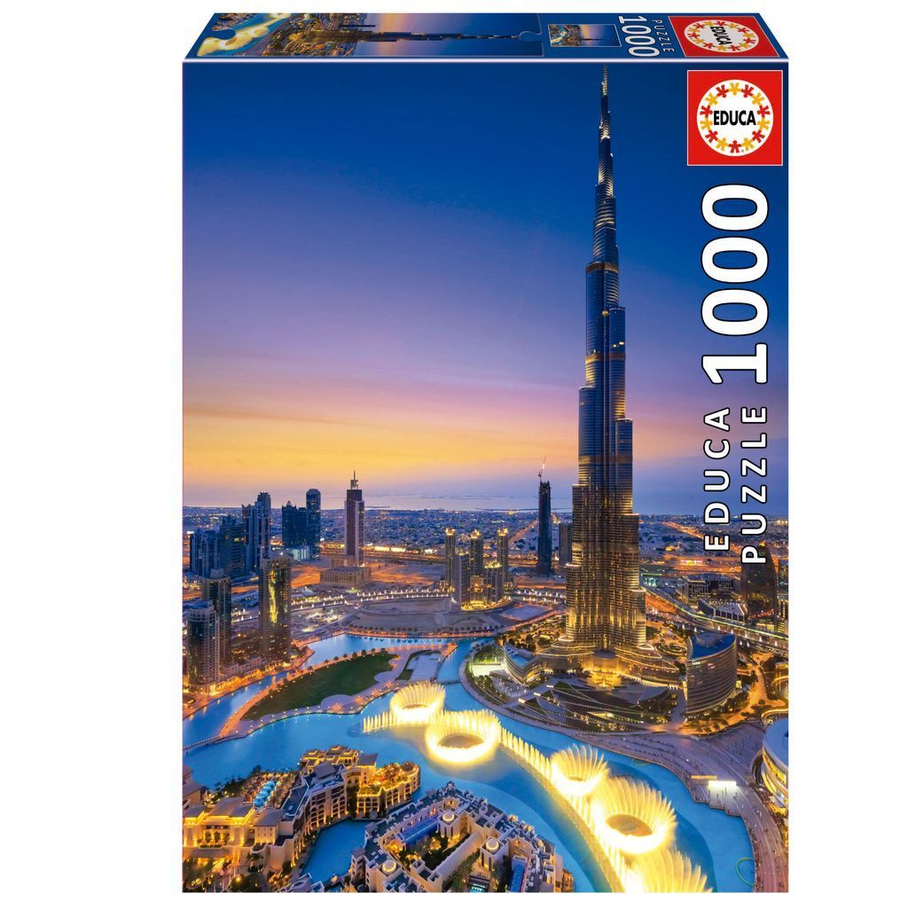 A panoramic aerial photograph of the Burj Khalifa in Dubai at twilight with glowing fountains in the foreground.