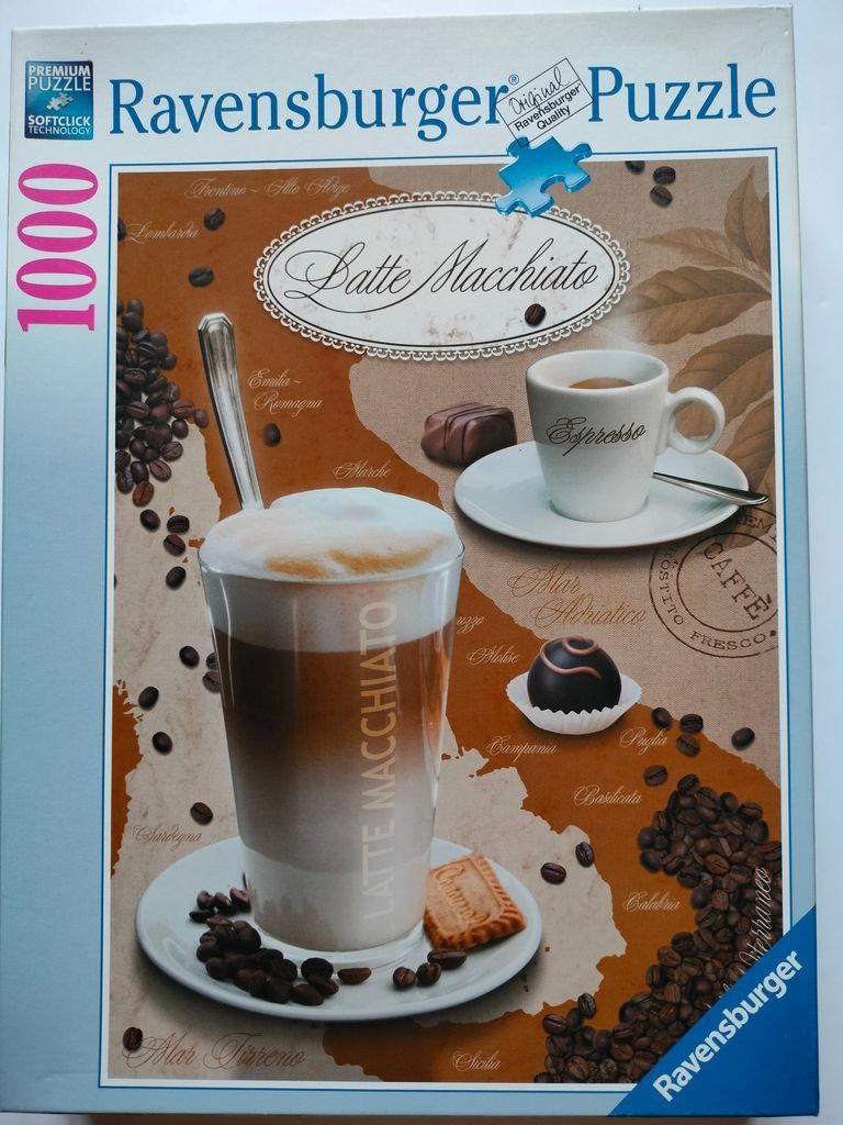 A latte macchiato and an espresso set against a map of Italy with coffee beans and a biscuit.