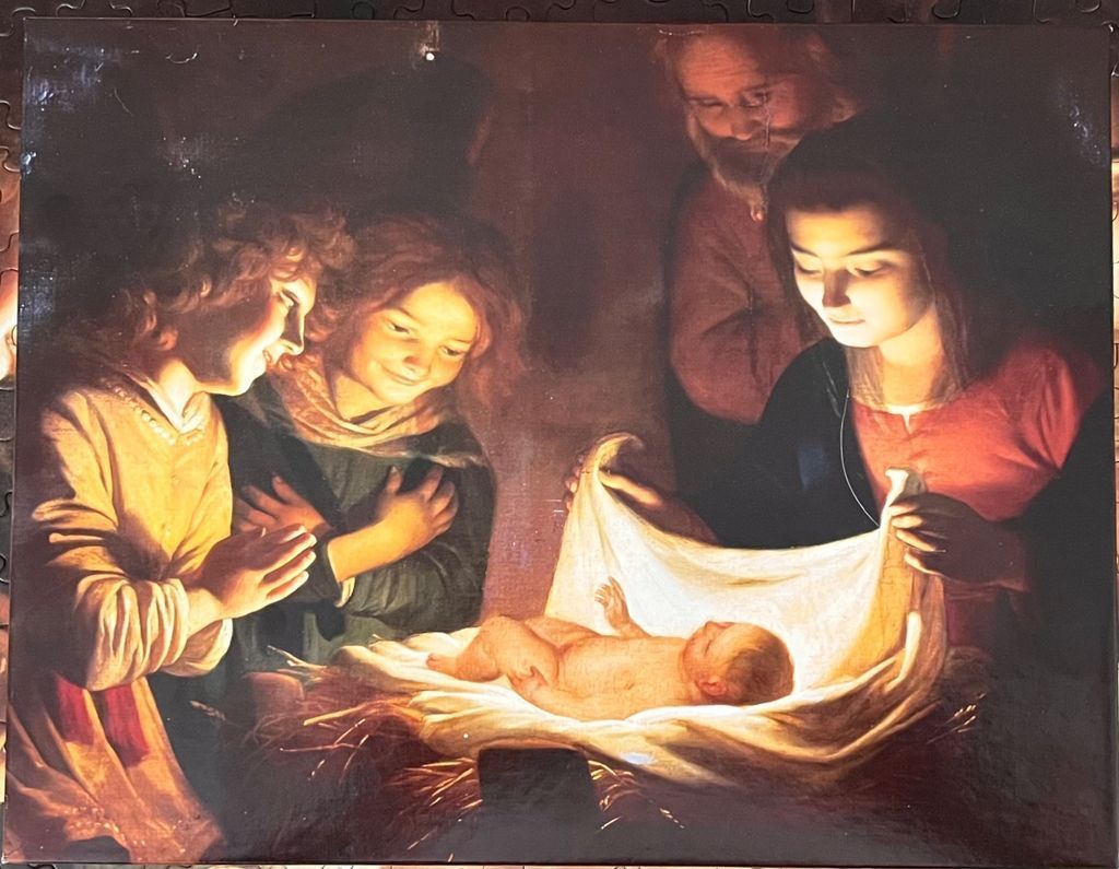 A classical oil painting of the nativity scene with the infant Christ illuminated in a manger.