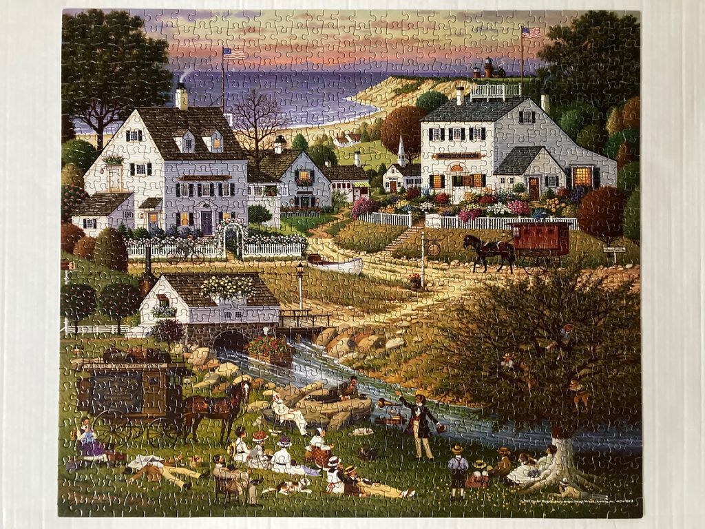 A peaceful 19th-century village scene with a horse-drawn carriage, a picnic by a stream, and white colonial-style houses.