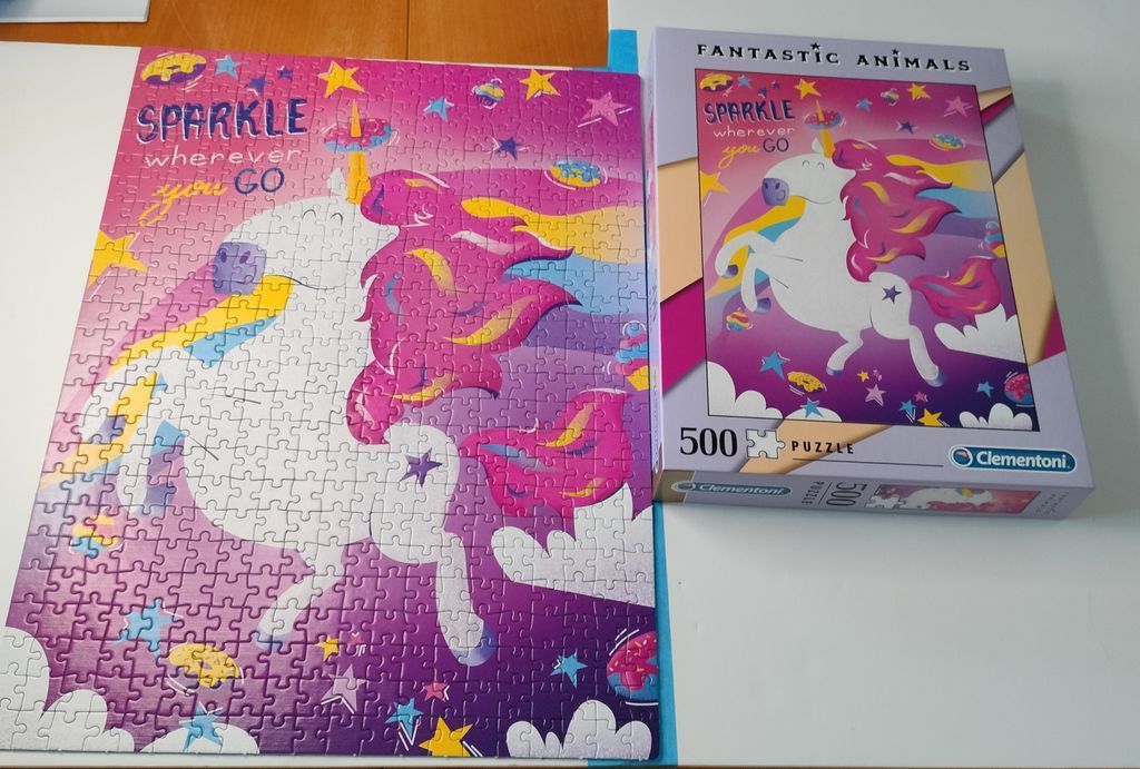 A cartoon unicorn jumping over a rainbow against a bright purple starry background with text.