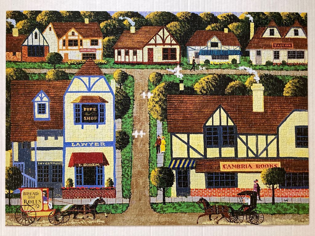 An illustration of a quaint village street with Tudor-style buildings, horse-drawn carriages, and local shops.