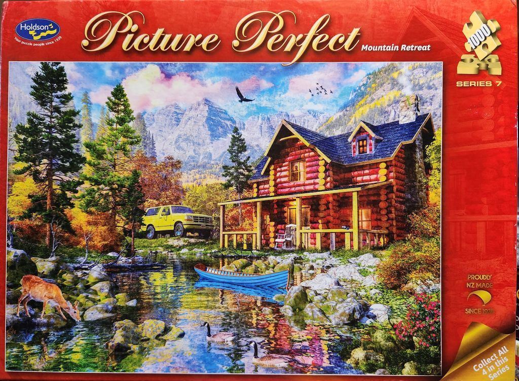A log cabin mountain retreat beside a stream with a yellow truck, a deer, and geese, in a vibrant autumn landscape.