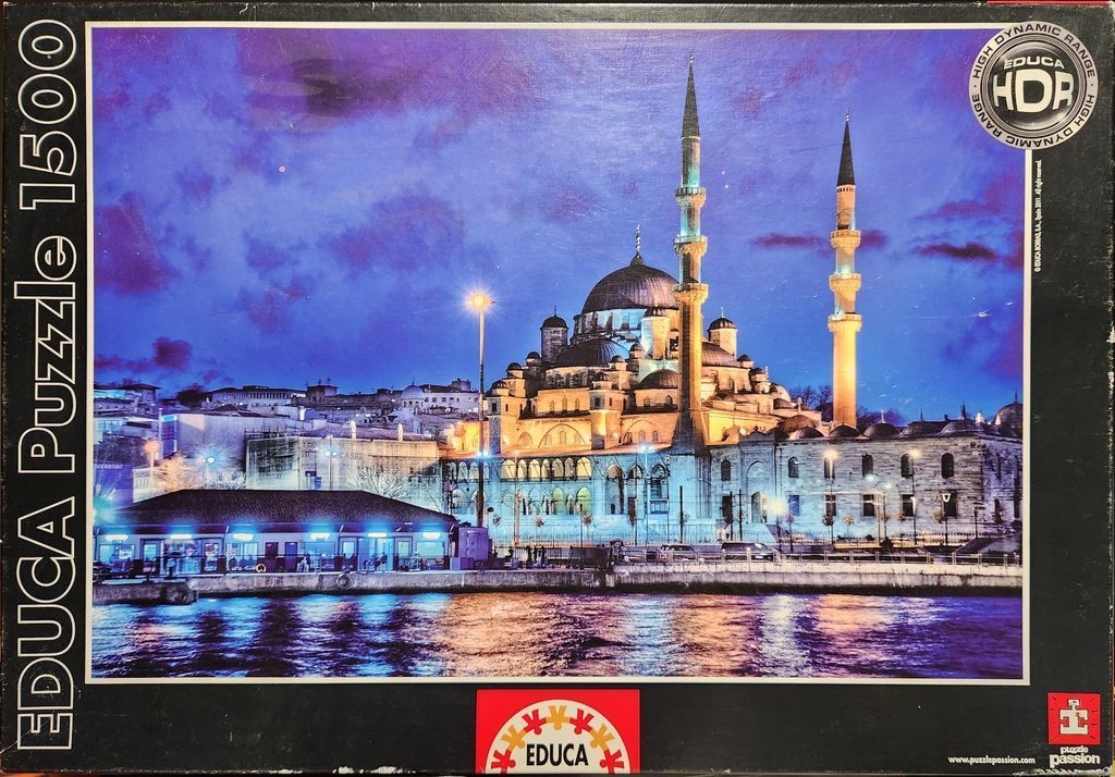 A twilight photograph of the Yeni Cami mosque in Istanbul illuminated against a vibrant purple sky.