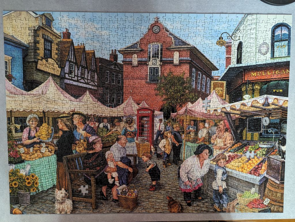 A bustling British village market scene with stone buildings, colorful stalls, and local people.