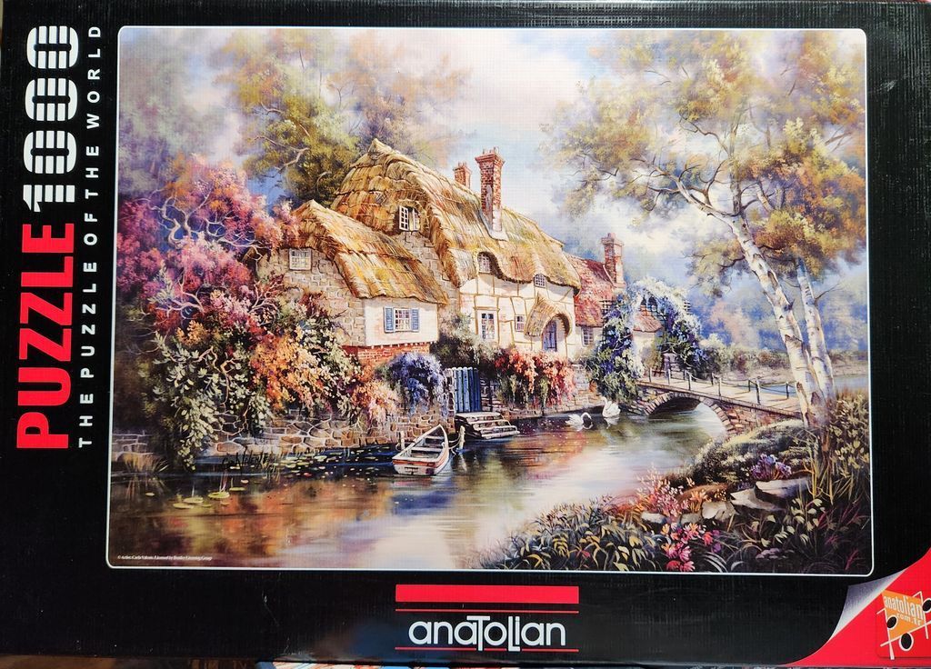 An oil painting of a quaint thatched cottage beside a pond with a stone bridge and lush autumn foliage.