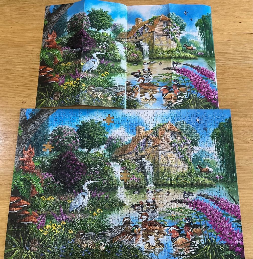 An idyllic countryside scene featuring a water mill, a stream, and various wildlife in a lush garden setting.