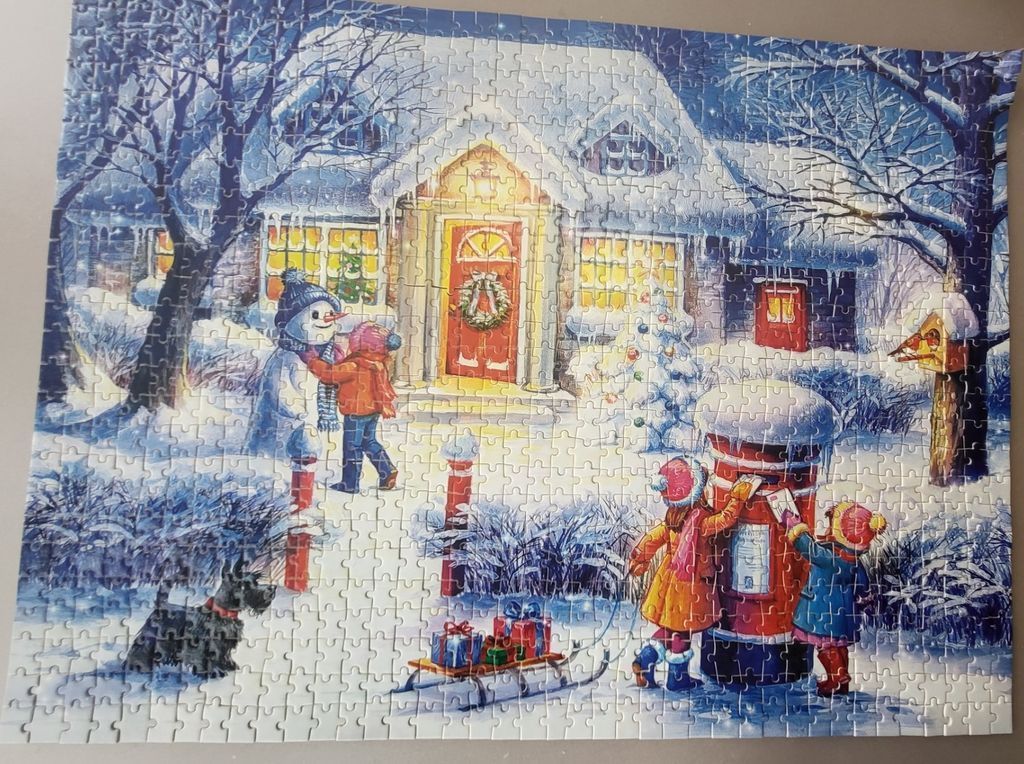 A cozy winter scene featuring a cottage, children posting mail, and a snowman in the snow.
