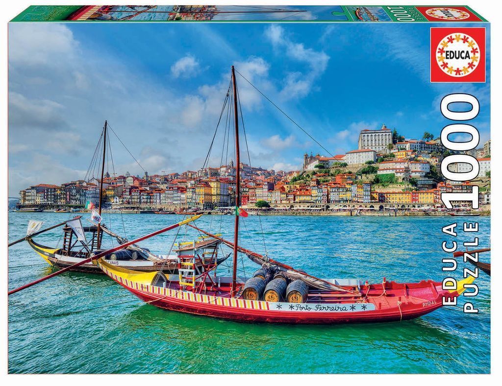 Traditional rabelo boats on the Douro River in Porto with colorful hillside buildings in the background.