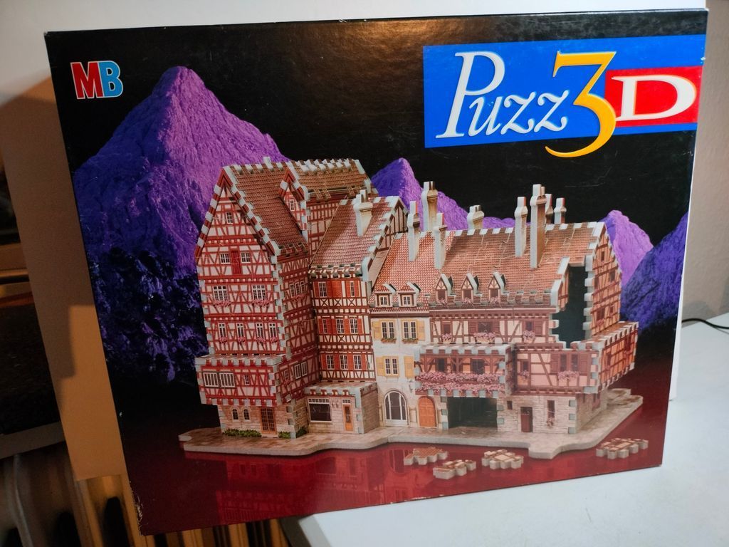 A detailed 3D model of a traditional half-timbered European building set against a purple mountain landscape.