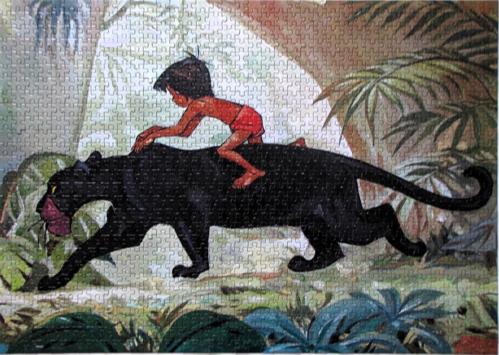 Mowgli the young boy riding on the back of Bagheera the black panther in a jungle setting
