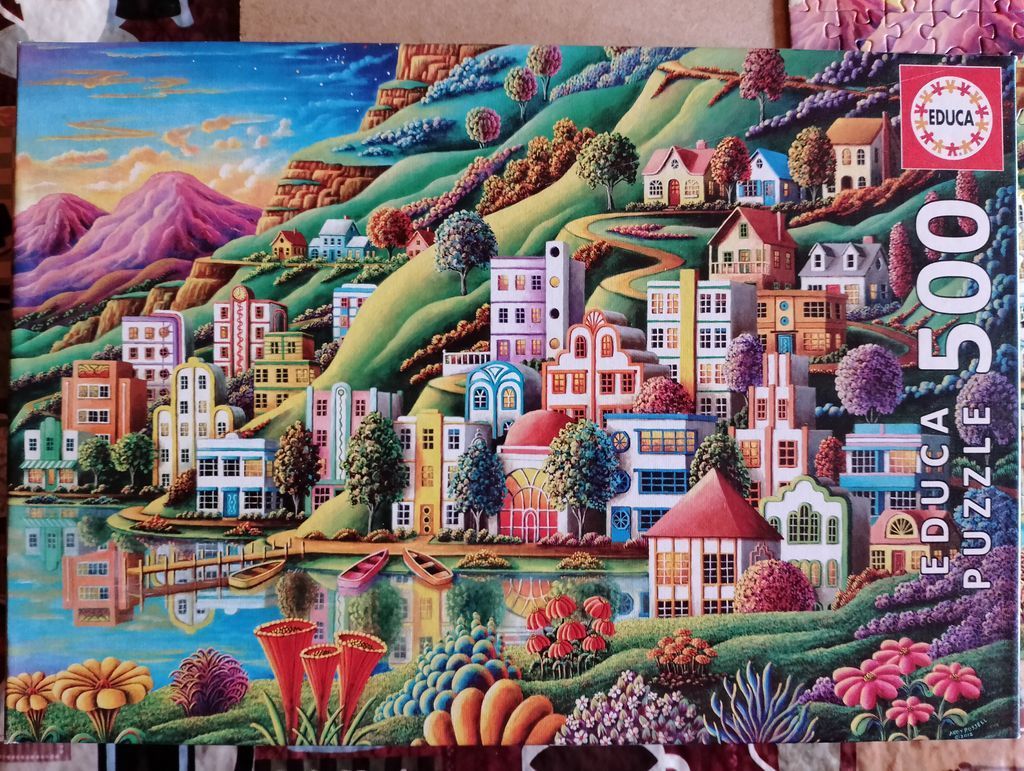 Whimsical illustration of a colourful lakeside town nestled against rolling green hills at sunset.