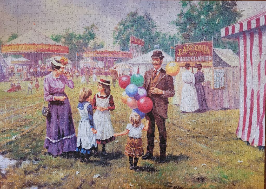 A Victorian-era fairground scene featuring a man with balloons, a woman, and children in historical clothing.