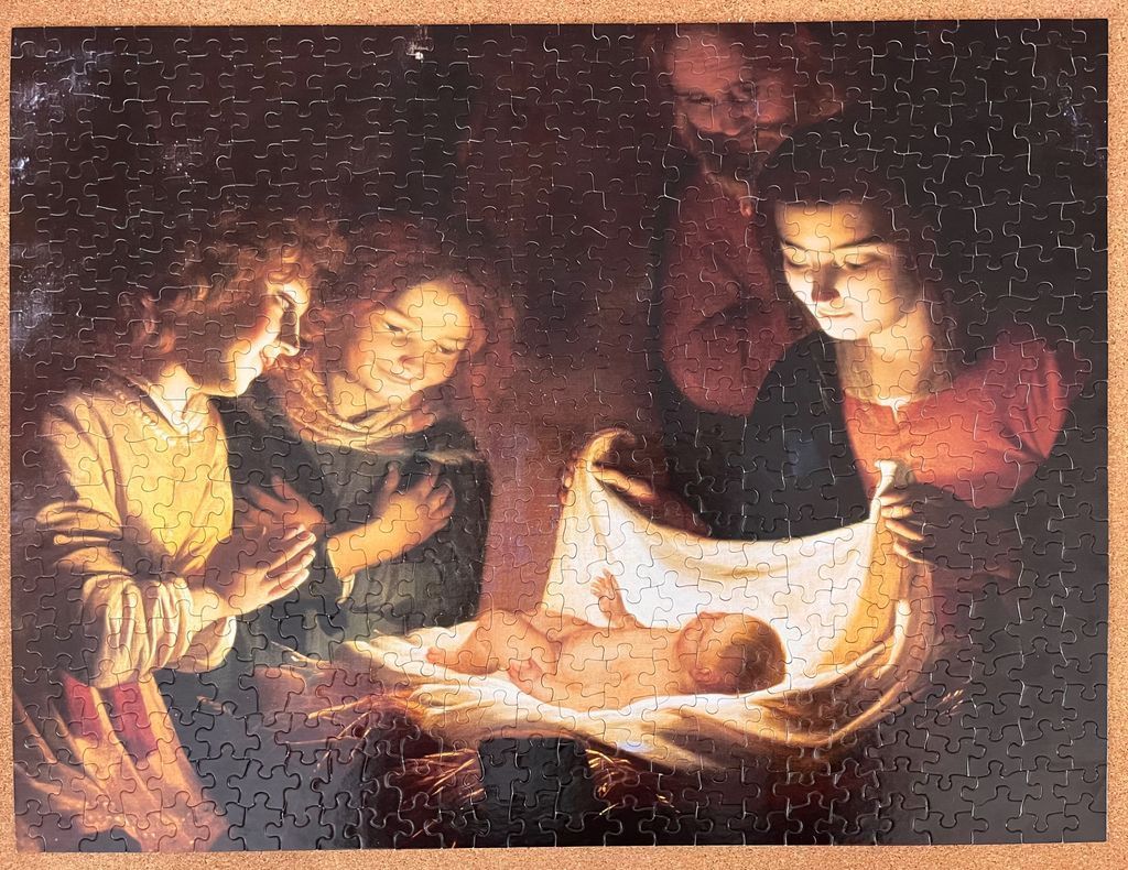 A classical oil painting depicting the nativity of Jesus with figures gathered around a glowing infant.