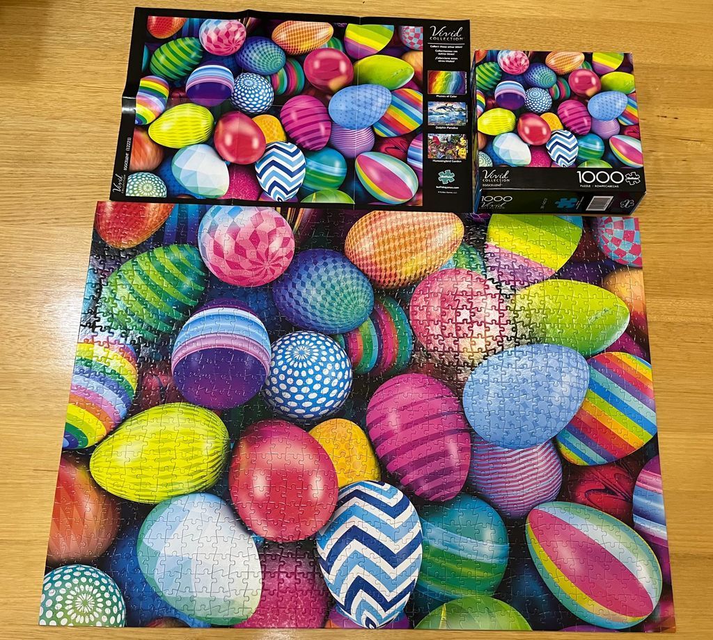 A collection of brightly colored, patterned Easter eggs overlapping each other.
