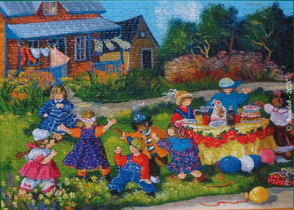 Children playing in a garden during a birthday party in front of a house