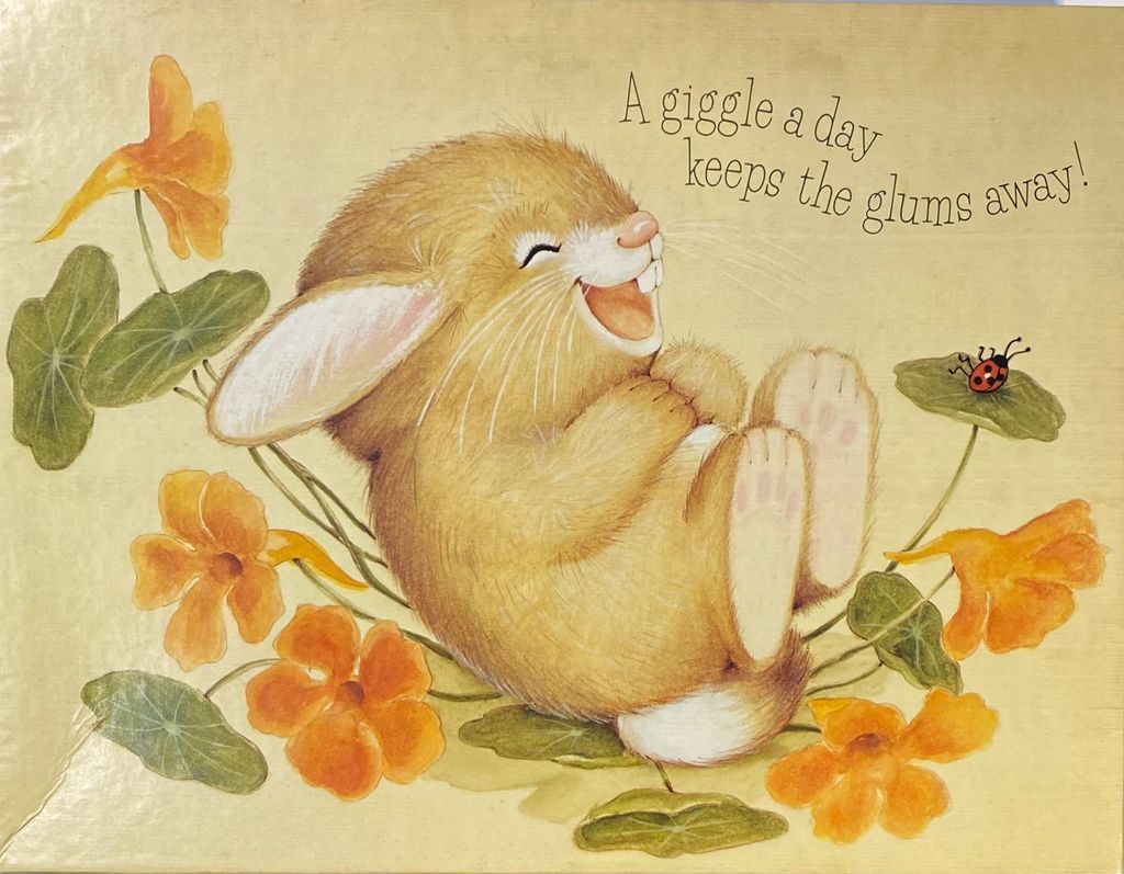 Illustration of a laughing brown bunny surrounded by orange nasturtium flowers on a light yellow background.