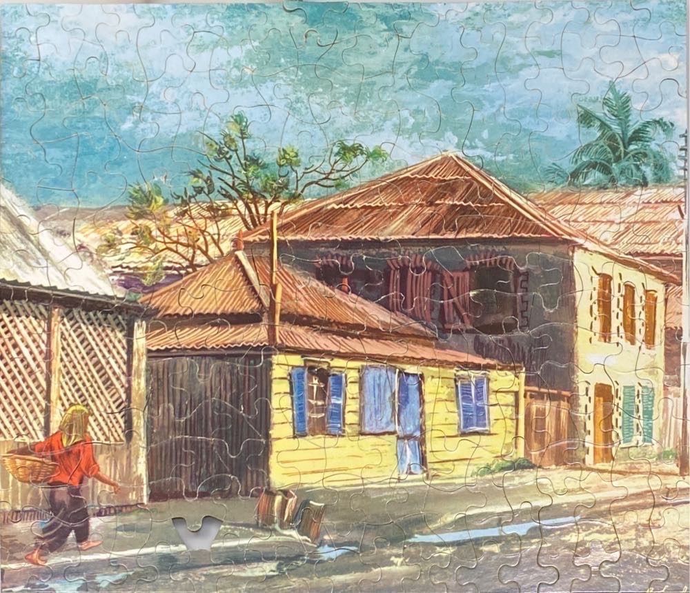 A painting of a yellow house with blue shutters in a tropical town, with a woman walking by in the foreground.