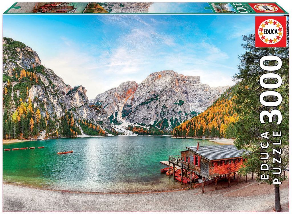 Lake Braies in the Dolomites with a wooden boat house and autumn foliage