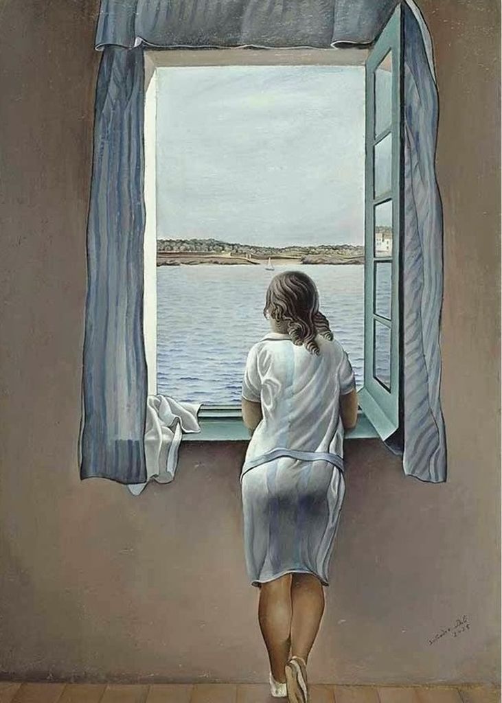 A young woman standing by a window, looking out over a calm sea toward a distant coastline.