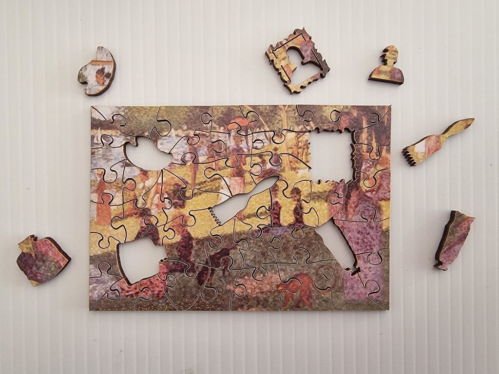 A partial recreation of Georges Seurat’s A Sunday Afternoon on the Island of La Grande Jatte with artist-themed cutouts.