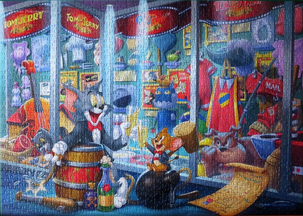 Cartoon illustration of Tom and Jerry inside a shop filled with movie memorabilia and props.