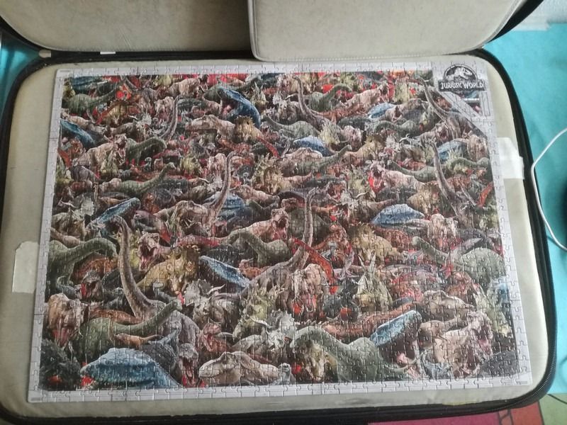 A dense illustration of many different dinosaurs crowded together in a chaotic scene.