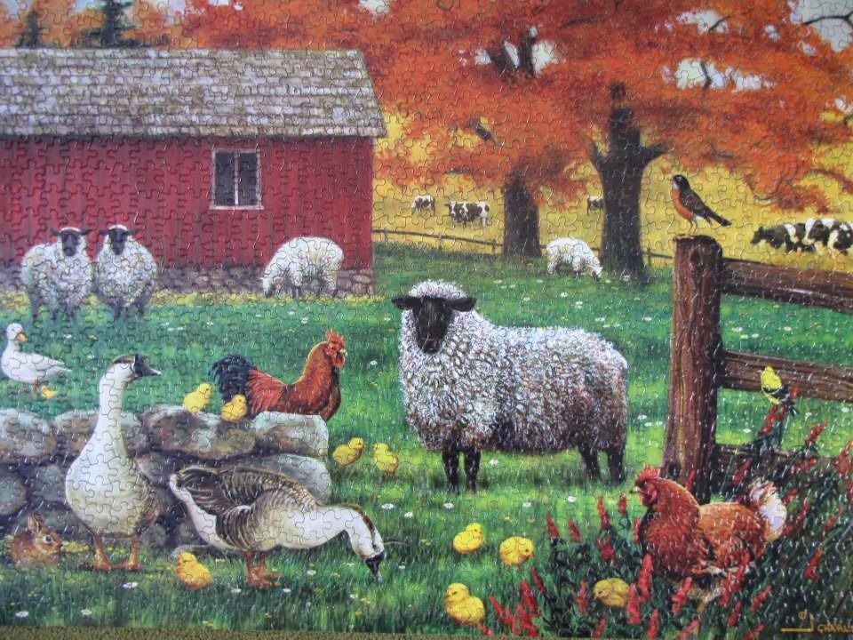 A peaceful farm scene with sheep, chickens, geese, and a red barn during autumn.