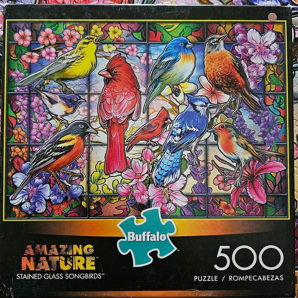 Stained glass illustration of nine colorful songbirds perched among vibrant flowers and grid lines.