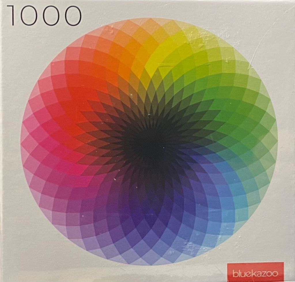 A circular geometric pattern of overlapping petal shapes in a spectrum of colors on a white background.