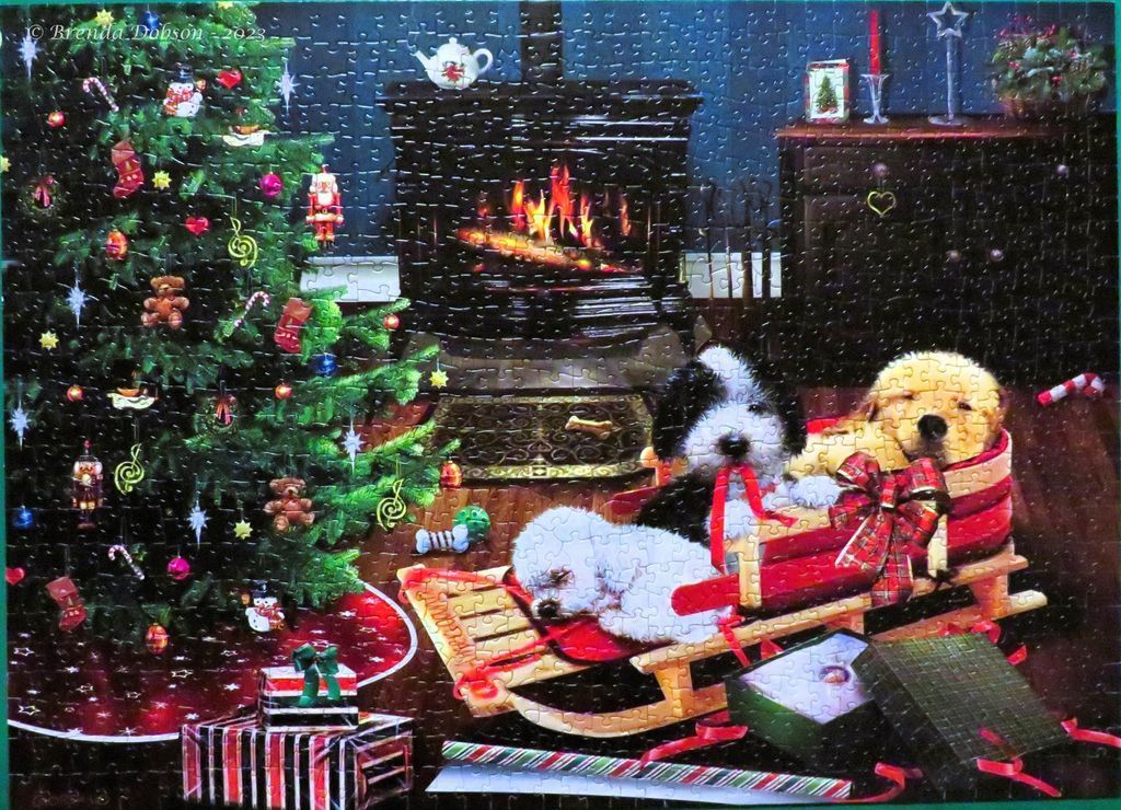 Two dogs resting on a wooden sled beside a decorated Christmas tree and a cozy fireplace.