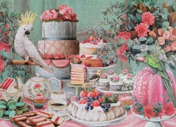 A whimsical afternoon tea scene featuring cakes, pastries, a white cockatoo, and a green parrot amidst floral decorations.