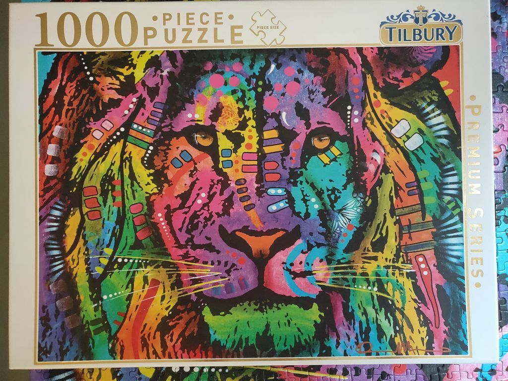 A vibrant pop-art style close-up illustration of a lion's face featuring rainbow colors and abstract patterns.