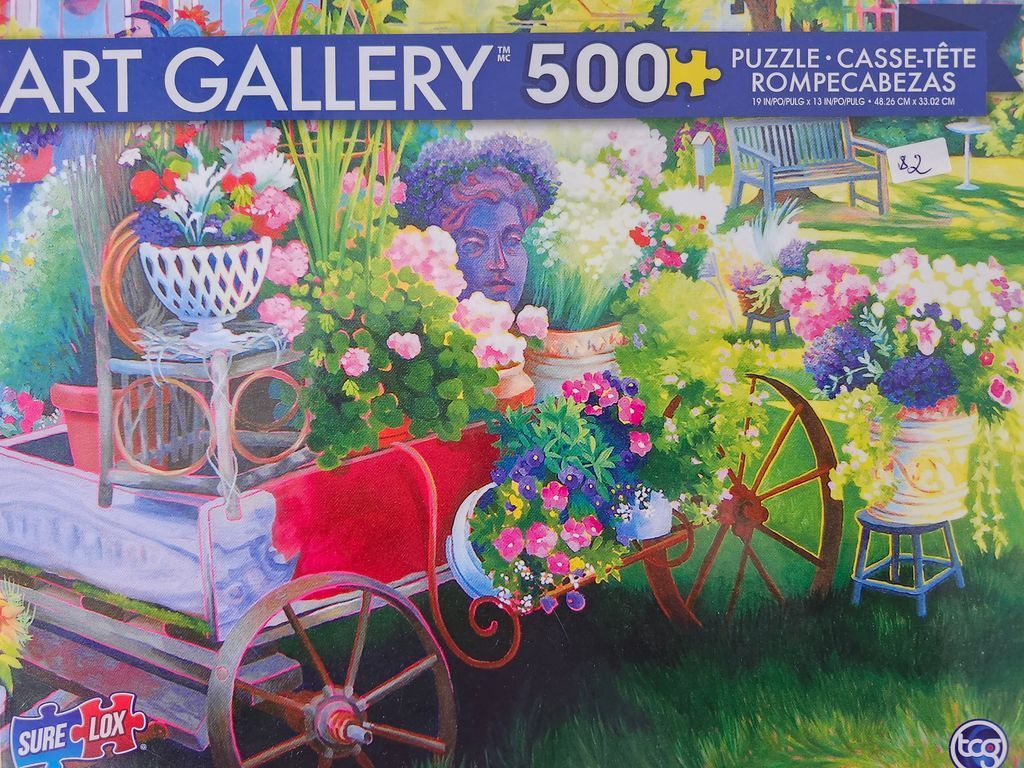An impressionist-style garden scene featuring a red rustic wagon overflowing with potted flowers and a stone bust.