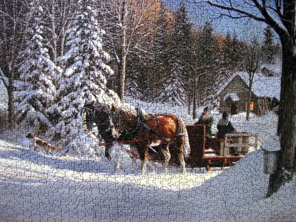 Horse-drawn sleigh driving through a snowy forest past a cabin