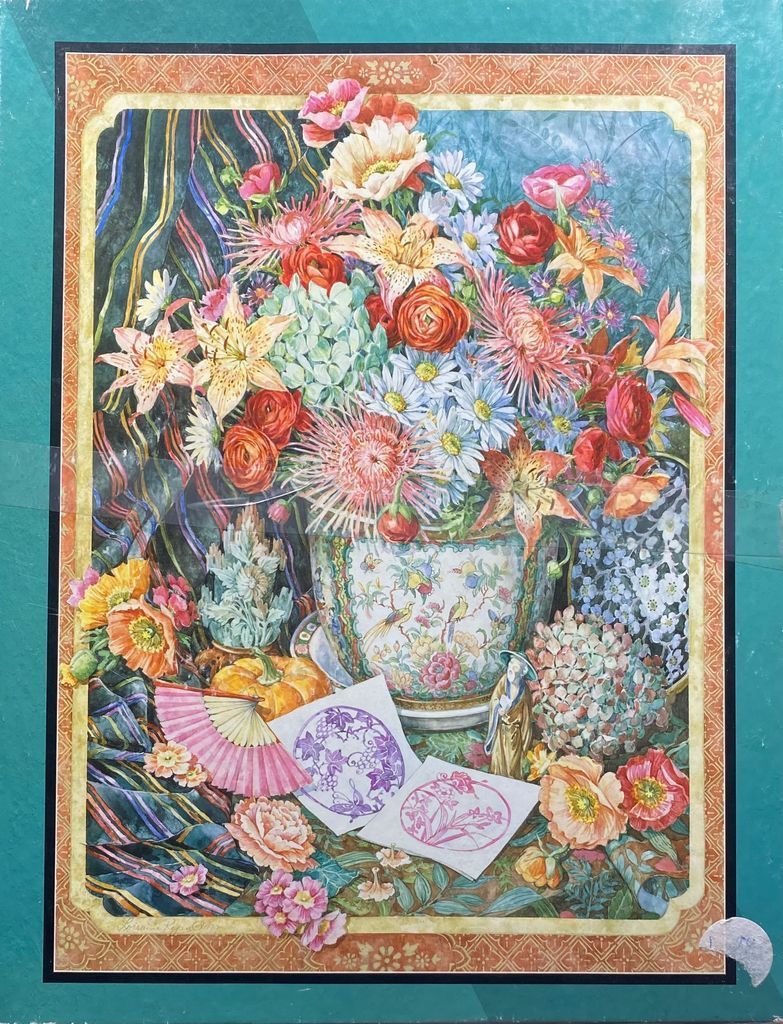 A lush still life oil painting of a vibrant floral bouquet in an ornate ceramic vase surrounded by decorative objects.