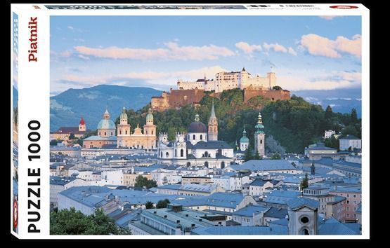 A scenic panoramic view of Salzburg, Austria, featuring the Hohensalzburg Fortress overlooking the old city rooftops.
