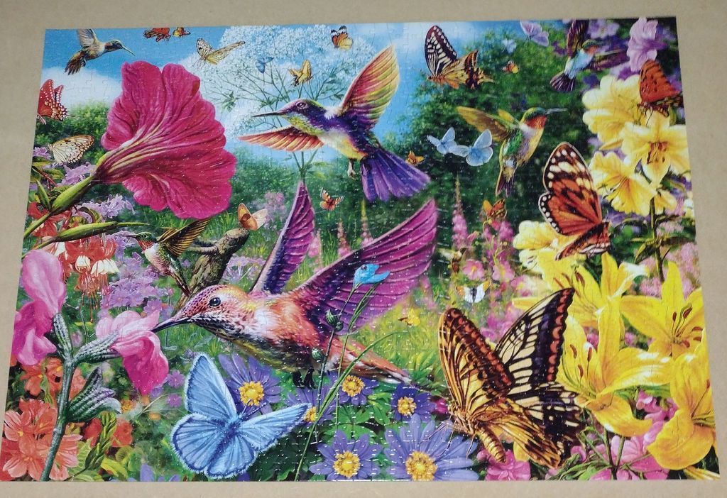 Vibrant garden scene featuring hummingbirds and butterflies among bright flowers.